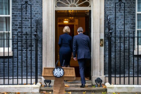 Liz Truss and her husband return inside after her resignation statement outside No 10