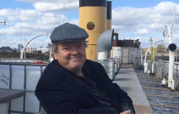 Actor Robbie Coltrane on board the Clyde steamer Queen Mary, which he helped rescue and restore
