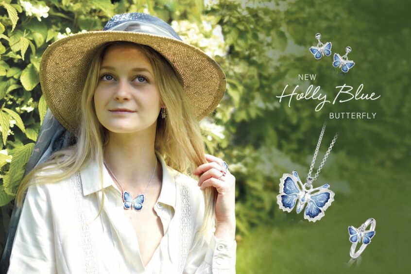 woman models pieces from Sheila Fleet's latest collection, Holly Blue Butterfly