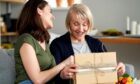 young woman gives a gift to an older woman. For something special, you'll find many gift ideas from Scotland