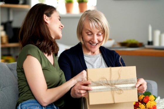 young woman gives a gift to an older woman. For something special, you'll find many gift ideas from Scotland