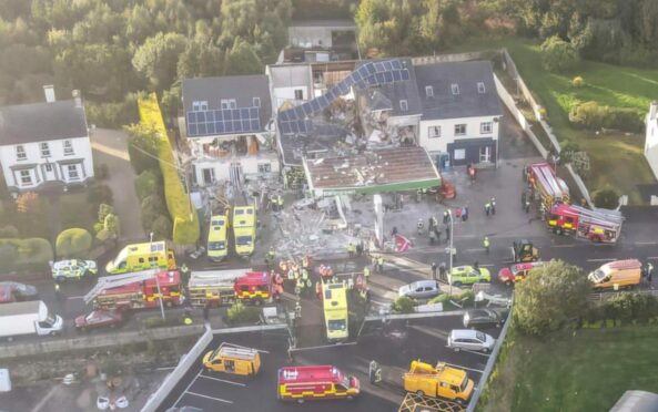 Police, fire service and ambulances at the scene yesterday after a huge explosion destroyed a petrol station in Creeslough, Donegal