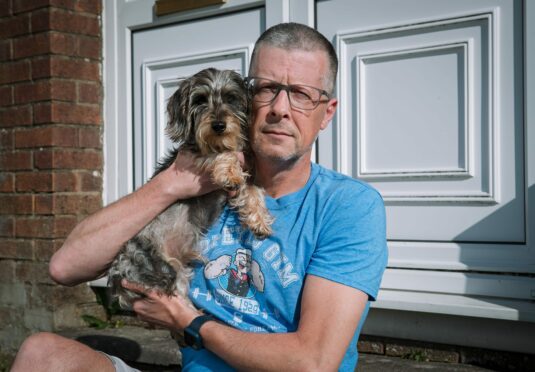 Andrew Cameron with dachshund Clyde at his East Kilbride home