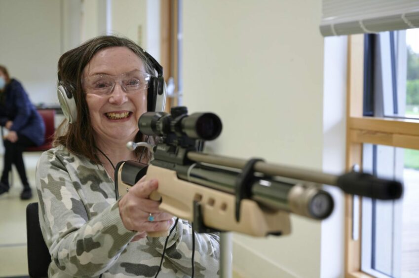 a photo of Janice at Sight Scotland Veterans, a sight-loss charity, doing a shooting activity