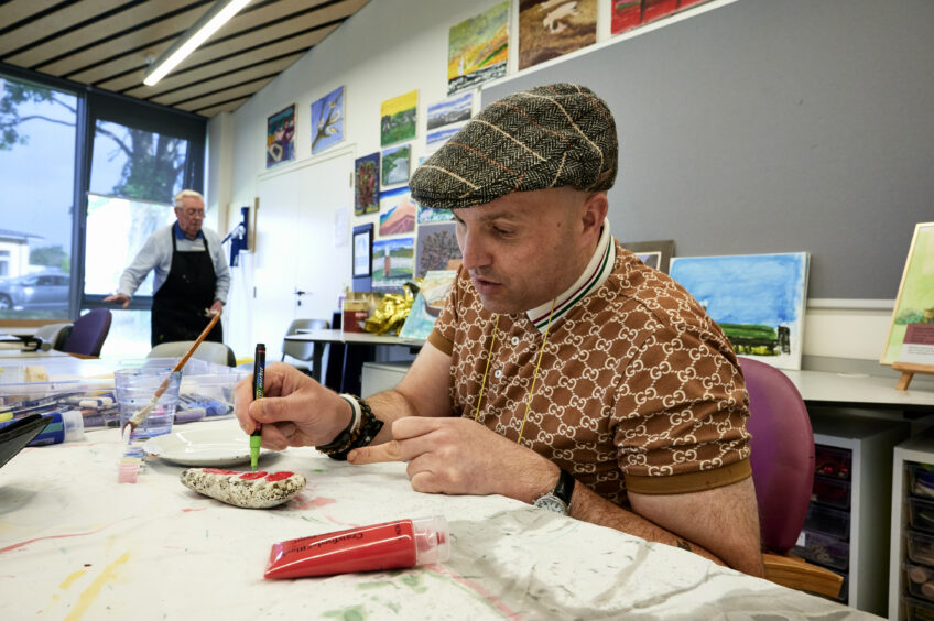 A photo of veteran David Martin in the art room at Sight Scotland Veterans' Centre