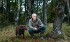 Dr Paul Thomas with truffle hound Whinnie on a hunt for the fungi in the woods on the Isle of Bute