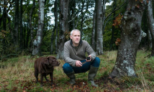 Dr Paul Thomas with truffle hound Whinnie on a hunt for the fungi in the woods on the Isle of Bute