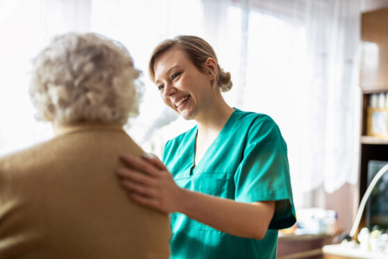 a lady in a care home with carer