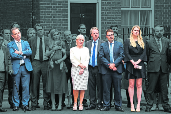 Joining his wife Carrie, aides and supporters line up behind Boris Johnson outside No 10 on July 7 as he announced his resignation as Prime Minister. Several are reportedly being given peerages in his resignation honours list: in colour from left to right, former minister of state Nigel Adams, ex-Culture Secretary Nadine Dorries, Scottish Secretary Alister Jack, former No 10 deputy chief of staff Ben Gascoigne and ex-Downing Street special adviser Charlotte Owen