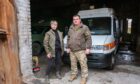 Volunteer Ivanna, left, and medic Zhenya with their ambulance in Donbas.