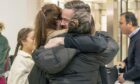 Relieved Scottish construction engineer Brian Glendinning is greeted by his wife Kimberly and daughters at Edinburgh Airport yesterday