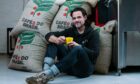 Pete Cavani grabs a seat with bags of his Kata coffee