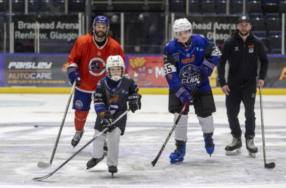 Ukrainian youngsters, Danylo Tetiana, aged nine, front left and 14-year-old Serhii Tymoshenko take to the ice at Braehead Arena with Clan associate coaches, Stephen Dickson and Dyson Stevenson.