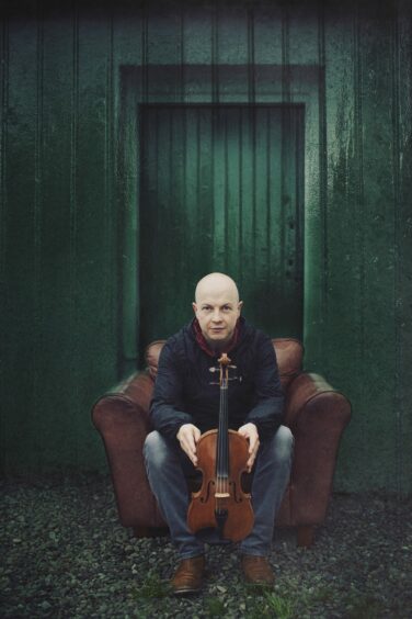 John McCusker with his fiddle before a performance at Birnam Arts Festival