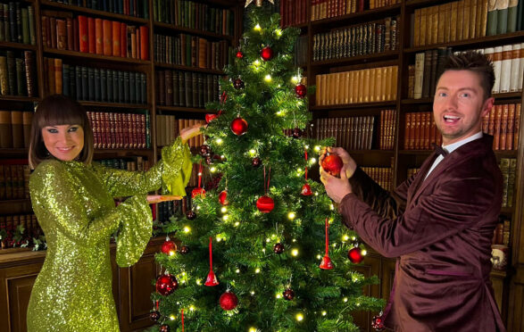 Pals Laura Boyd and Sean Batty add the finishing touches to the Christmas tree