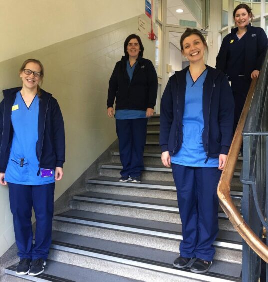 A group of PATCH nurses standing in a hospital stairwell.