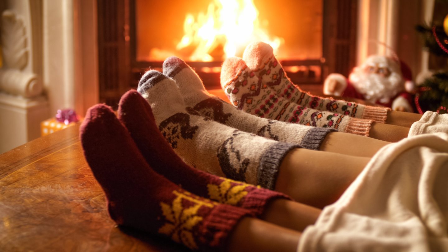 feet in cosy slipper socks in front of fire