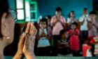 A teacher leads pupils at a Leprosy Centre in West Bengal, left, and Dr Renuka Ramakrishnan, above.