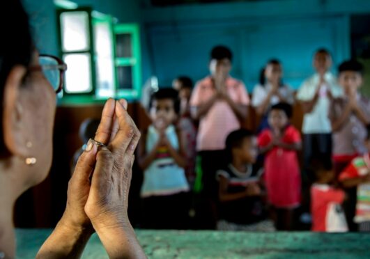 A teacher leads pupils at a Leprosy Centre in West Bengal, left, and Dr Renuka Ramakrishnan, above.