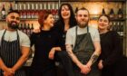 Head chef Robbie Smith, second right, and colleagues at Hooligan Wine in Glasgow, where customers dine in the former living room of a traditional tenement flat