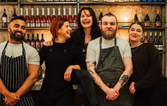 Head chef Robbie Smith, second right, and colleagues at Hooligan Wine in Glasgow, where customers dine in the former living room of a traditional tenement flat