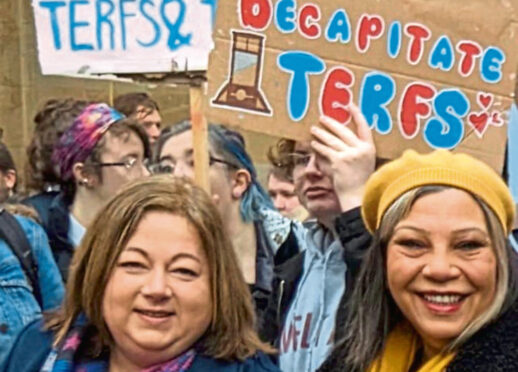 Kirsten Oswald and Kaukab Stewart under the poster at the demo in Glasgow yesterday.