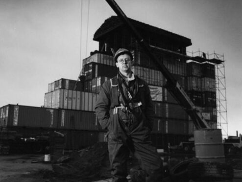 David Mach oversees work on his Temple At Tyre, made from shipping containers, in Leith Docks in 1994.