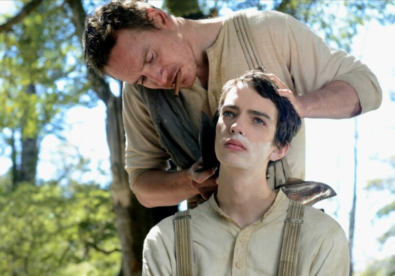 Michael Fassbender and Kodi Smi-McPhee as Silas Selleck and Jay Cavendish in the 2015 film, Slow West