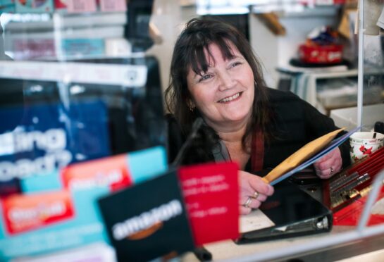 Susan Craddock sorts mail at her Post Office in Largs