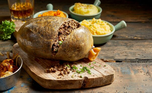 Cooked haggis and vegetables