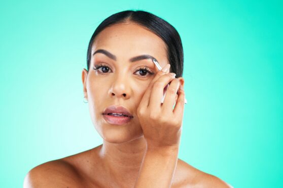 Woman using tweezers