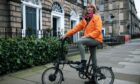 Kim Howard, with her electric bike in Edinburgh, is recovering after life-threatening brain injuries suffered when she crashed in October 2021.