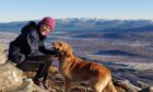 Merryn Glover with her dog in the Monadhliaths with the Cairngorms in the background, the mountains that so inspired Nan Shepherd.