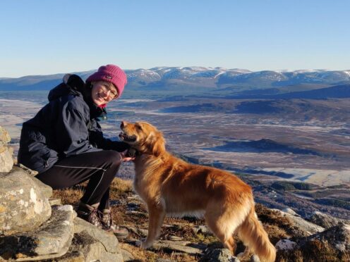 Merryn Glover with her dog in the Monadhliaths with the Cairngorms in the background, the mountains that so inspired Nan Shepherd.