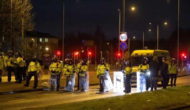 Police in riot gear after a demonstration outside the Suites Hotel in Knowsley, Merseyside, where people were protesting against asylum seekers staying at the hotel.