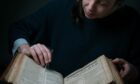 Conservator Keira McKee undertakes delicate repair work to the Shakespeare First Folio at Glasgow University