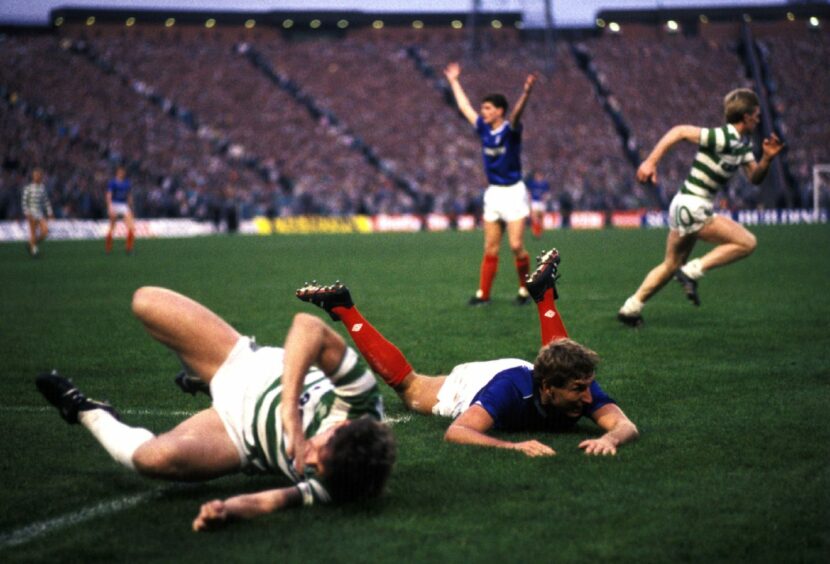 Terry Butcher is brought down by Celtic skipper Roy Aitken for the penalty that Davie Cooper would convert to secure Skol League Cup success in 1986