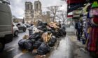 Rubbish piled up near Notre Dame in Paris as French workers strike over pension reforms