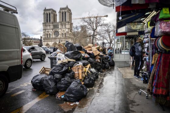 Rubbish piled up near Notre Dame in Paris as French workers strike over pension reforms
