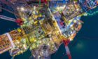 An aerial view of an offshore oil rig drilling platform at night