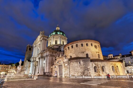 The Old and New Cathedrals of Brescia at night.