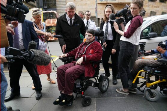 Nicholas Rossi arrives at court in Edinburgh in July last year in a wheelchair for his extradition case