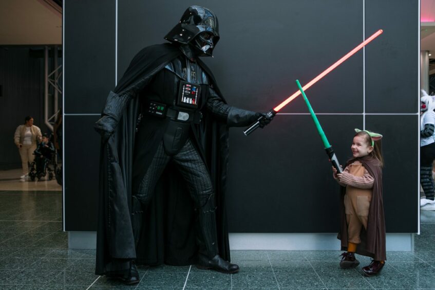 Theodora Ferrari, age 3, from Brazil, dressed as Yoda, with Darth Vader