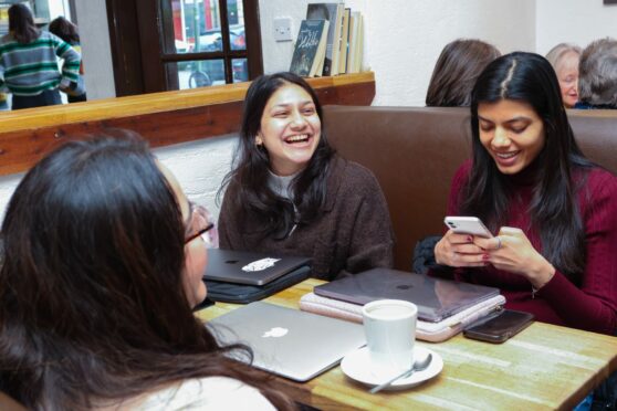 Disha Mehta, left, chats with Sonia Raheja, right, in Coffee Angel in Edinburgh
