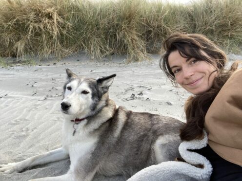 Cal Flynn and her dog, Suka, on the Isle of Eigg