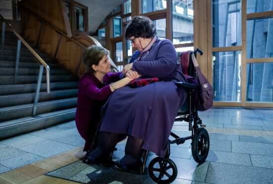 Then first minister Nicola Sturgeon shares a moment with Marion McMillan after her apology in parliament.
