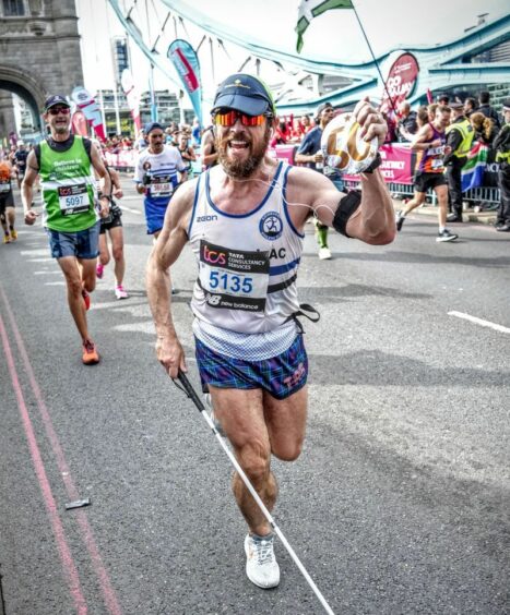 A photo of blind marathon runner Steven Waterston running a marathon.