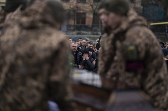 Iryna Tsyhanska, centre, cries at the funeral of soldier husband Roman in Lviv on Friday. He was killed at Bakhmut