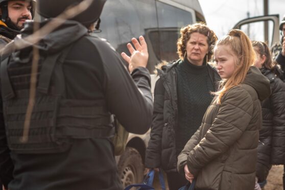 Olya and daughters prepare to board minibus out of devastated Siversk