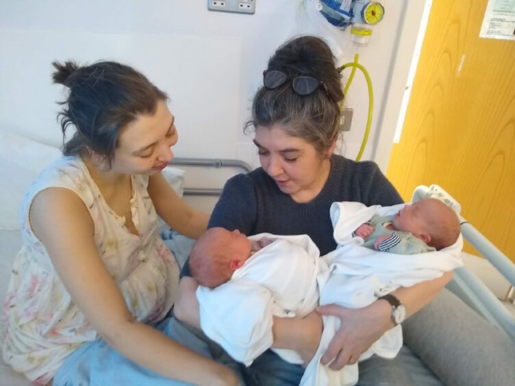 Mollie Hinshelwood, left, with newborn twins Otis Alan and Jimmy Jet and mum Alison Eldridge, who was in Lesley Banks’ original 1993 painting